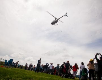 A helicopter dropped thousands of Easter eggs on to the River Fields in Northeast Philadelphia Saturday. (Brad Larrison for WHYY)