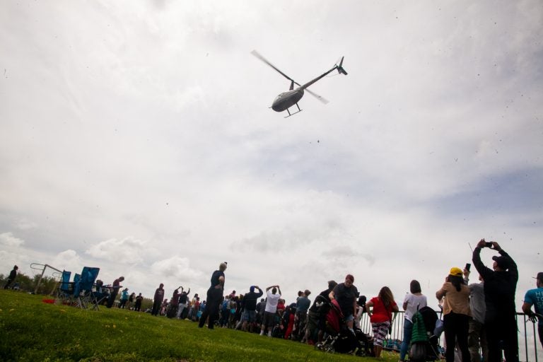 A helicopter dropped thousands of Easter eggs on to the River Fields in Northeast Philadelphia Saturday. (Brad Larrison for WHYY)