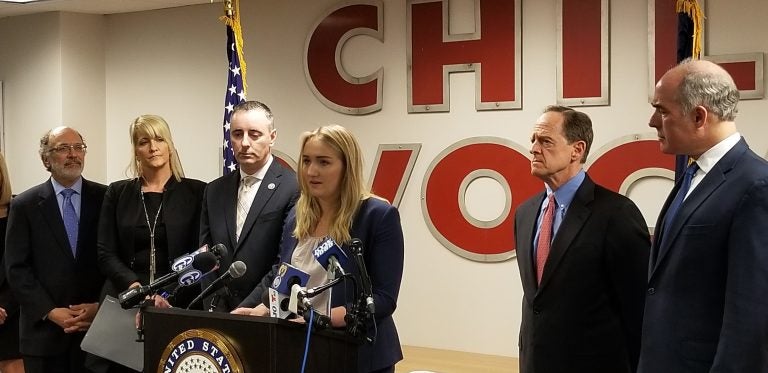 Madison Zezzo, center, speaks about the Combat Online Predators Act flanked by U.S. Rep. Brian Fitzpatrick (left) and U.S. Sens. Pat Toomey and Bob Casey (right). (Tom MacDonald/WHYY)