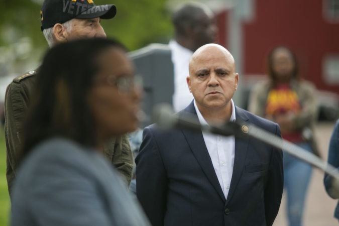 Frank Moran stand by as Camden Schools superintendent, Katrina McCombs offer remarks in a community rally held in Camden to create safer environment for children on Thursday, April 25, 2019. (Miguel Martinez for WHYY)