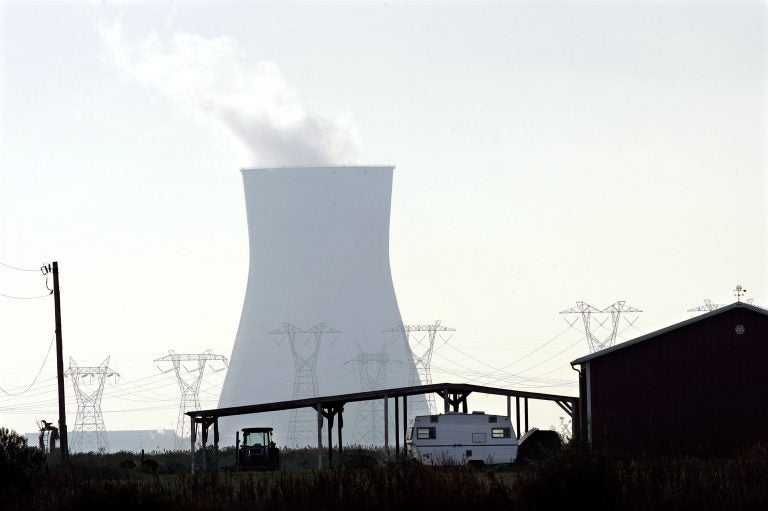 This file picture shows a cooling tower at the Salem nuclear power plant owned by the Public Service Energy Group and a building on a small farm in Lower Alloways Creek Township, N.J., in rural Salem County. (Mel Evans/AP Photo)