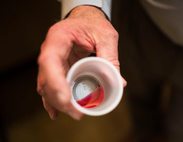 In this March 7, 2017, file photo, the CEO of a methadone clinic holds a 35 mg liquid dose of methadone. (Kevin D. Liles/AP Photo, File)