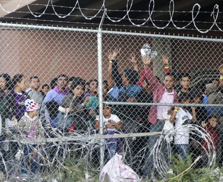 Central American migrants wait for food in El Paso, Texas, Wednesday, March 27, 2019, in a pen erected by U.S. Customs and Border Protection to process a surge of migrant families and unaccompanied minors.  (Cedar Attanasio/AP Photo)