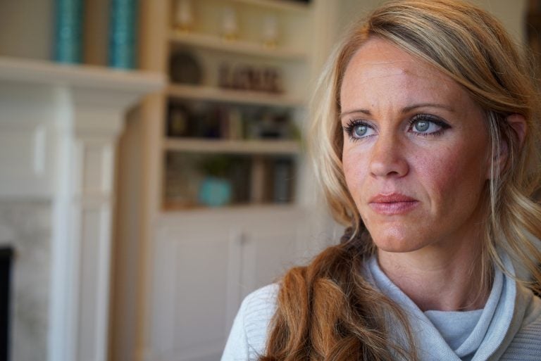 In this March 27, 2019, photo, Kacey Ruegsegger Johnson poses for a portrait at her home in Cary, N.C. Ruegsegger Johnson, now a mother of four, survived a shotgun blast during the 1999 shootings at Colorado's Columbine High School that left 12 students, one teacher, and both gunmen dead. (Allen G. Breed/AP Photo)