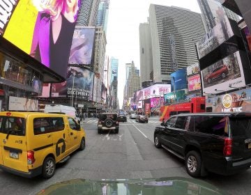 Motorists roll south on 7th Avenue in Times Square, Friday, March 29, 2019, in New York.  Long ringed by some of the most expensive toll roads in the U.S., New York City is poised to take things even further with a plan to use automated license plate readers to charge drivers who motor into the most congested parts of Manhattan during times when crosstown traffic is at its worst.(AP Photo/Julie Jacobson)