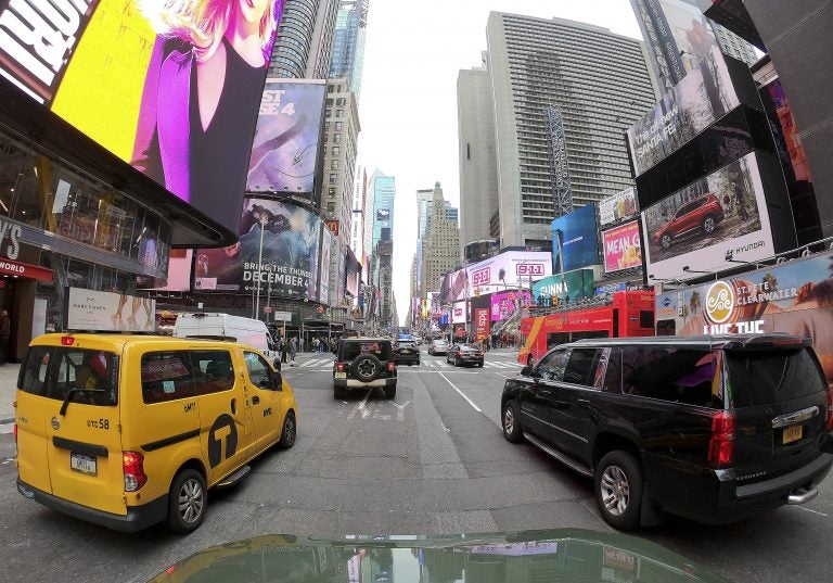 Motorists roll south on 7th Avenue in Times Square, Friday, March 29, 2019, in New York.  Long ringed by some of the most expensive toll roads in the U.S., New York City is poised to take things even further with a plan to use automated license plate readers to charge drivers who motor into the most congested parts of Manhattan during times when crosstown traffic is at its worst.(AP Photo/Julie Jacobson)