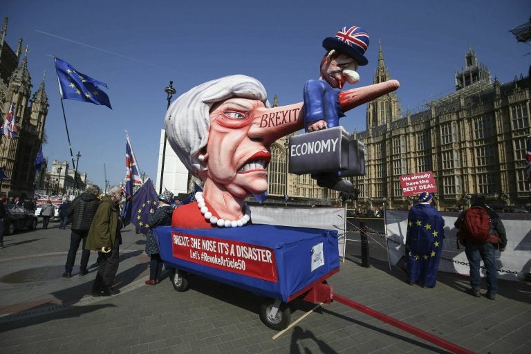 Anti-Brexit demonstrators with an effigy of British Prime Minister Theresa May near College Green at the Houses of Parliament in London, Monday, April 1, 2019. (Jonathan Brady/PA via AP)