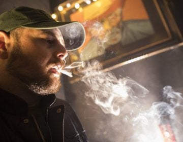In this Friday, March 29, 2019 photo, a man smokes marijuana at a Spleef NYC canna-cocktail party in New York. As more states make it legal to smoke marijuana, some government officials, researchers and others worry what that might mean for one of the country's biggest public health successes: curbing cigarette smoking. (Mary Altaffer/AP Photo)