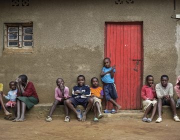 In this photo taken Thursday, April 4, 2019, the children of genocide survivors and perpetrators play together in the reconciliation village of Mbyo, near Nyamata, in Rwanda. Twenty-five years after the genocide the country has six 