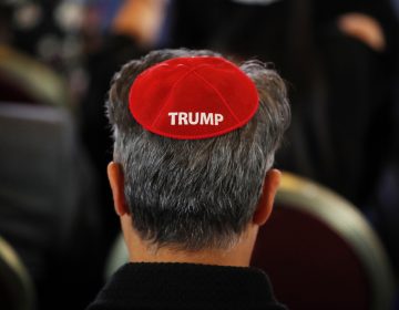 An attendee wears a yarmulke with the word 