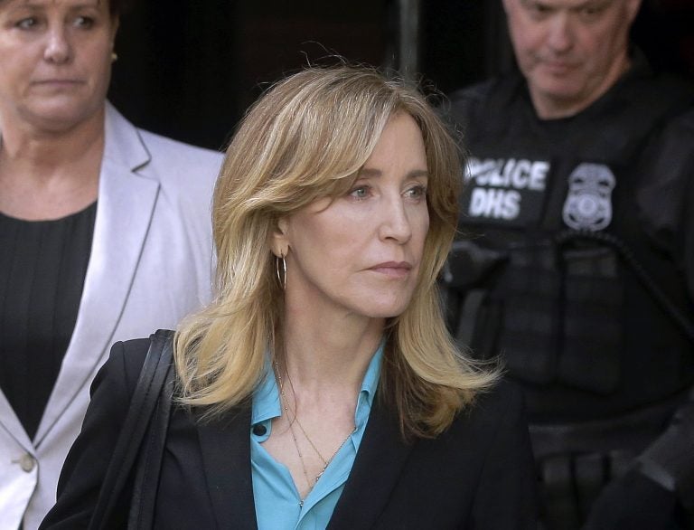 In this April 3, 2019 file photo, actress Felicity Huffman arrives at federal court in Boston to face charges in a nationwide college admissions bribery scandal. In a court filing on Monday, April 8, 2019, Huffman agreed to plead guilty in the cheating scam. (Steven Senne/AP Photo)