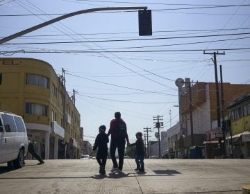 In this March 5, 2019 file photo, Ruth Aracely Monroy walks with her sons in Tijuana, Mexico. After requesting asylum in the United States, the family was returned to Tijuana to wait for their hearing in San Diego. (Gregory Bull/AP Photo)