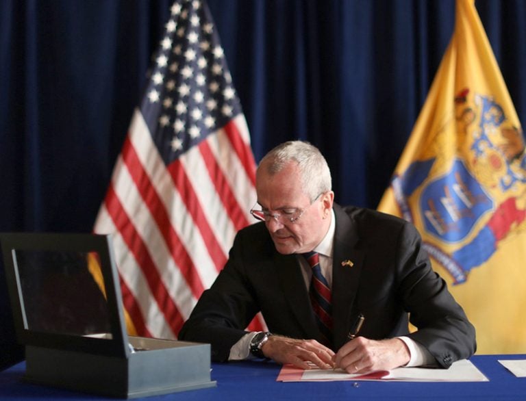 In this photo provided by the New Jersey Office of the Governor, N.J. Gov. Phil Murphy signs the Medical Aid in Dying for the Terminally Ill Act Friday, April 12, 2019 at the New Jersey Statehouse in Trenton, N.J. (New Jersey Office of the Governor via AP)