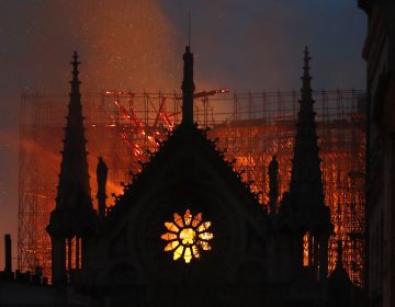 Flames and smoke rise from Notre Dame cathedral as it burns in Paris, Monday, April 15, 2019. Massive plumes of yellow brown smoke filled the air above Notre Dame Cathedral and ash fell on tourists and others around the island that marks the center of Paris. (Thibault Camus/AP Photo)