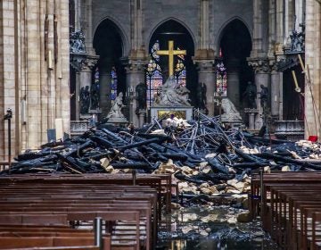A hole is seen in the dome inside Notre Dame cathedral in Paris, Tuesday, April 16, 2019. Firefighters declared success Tuesday in a more than 12-hour battle to extinguish an inferno engulfing Paris' iconic Notre Dame cathedral that claimed its spire and roof, but spared its bell towers and the purported Crown of Christ. (Christophe Petit Tesson, Pool via AP)