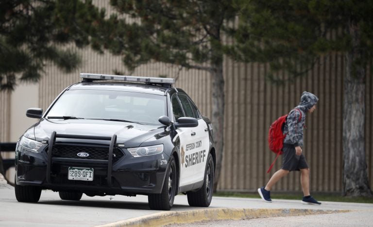 A student leaves Columbine High School late Tuesday, April 16, 2019, in Littleton, Colo. Following a lockdown at Columbine High School and other Denver area schools, authorities say they are looking for a woman suspected of making threats. (David Zalubowski/AP Photo)