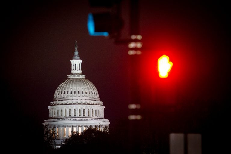 The Capitol is seen before sunrise in Washington, Thursday, April 18, 2019. (AP Photo/Cliff Owen)