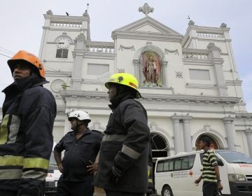 Sri Lankan firefighters stand in the area around St. Anthony's Shrine after a blast in Colombo, Sri Lanka, Sunday, April 21, 2019. Witnesses are reporting two explosions have hit two churches in Sri Lanka on Easter Sunday, causing casualties among worshippers. (Eranga Jayawardena/AP Photo)