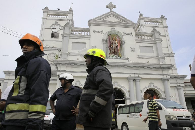 Sri Lankan firefighters stand in the area around St. Anthony's Shrine after a blast in Colombo, Sri Lanka, Sunday, April 21, 2019. Witnesses are reporting two explosions have hit two churches in Sri Lanka on Easter Sunday, causing casualties among worshippers. (Eranga Jayawardena/AP Photo)