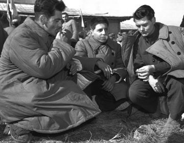 In this January 1954 file photo, three Americans who refused repatriation, take a smoke break outside the peace hut at Panmunjom, Korea. They were among 21 U.S. prisoners of war who refused to come home after the Korean War. The new PBS documentary 