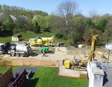 In this file photo, Mariner East 2 pipeline construction crews work in the backyards of homes on Lisa Drive in West Whiteland Township, Chester County, on May 2, 2018 after sinkholes opened in the area. That caused one of the ME2 project's many delays. (Marie Cusick/WITF)