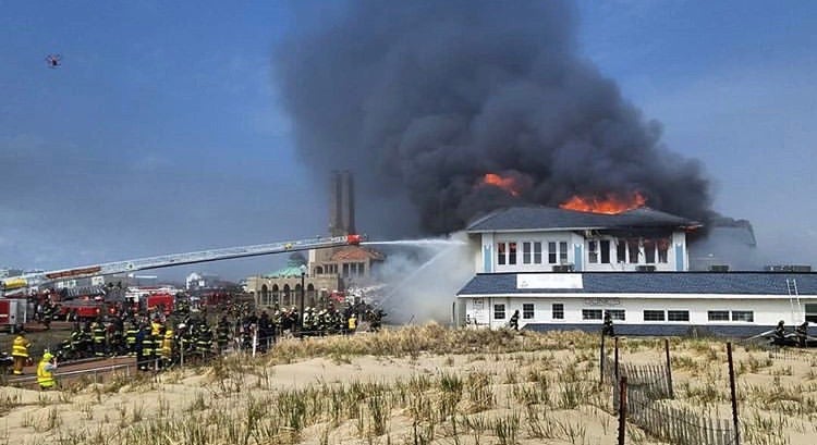 Firefighter battle a fire in the Dunes Cafe building on the Ocean Grove boardwalk Saturday afternoon. (Image courtesy of Chris Spiegel/Blur Revision Media Design)