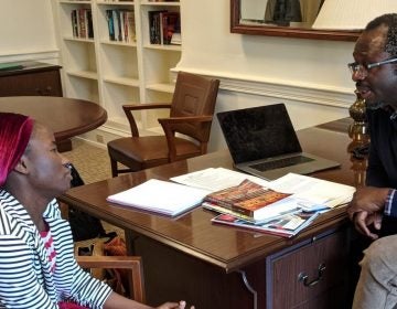 Patience Bulus speaks with Professor Jacob Udo-Udo Jacob in his office at Dickinson College. (Rachel McDevitt/WITF)