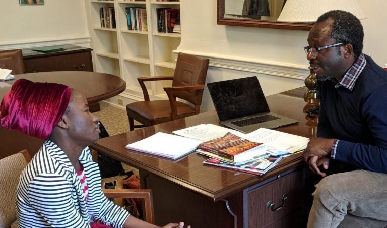Patience Bulus speaks with Professor Jacob Udo-Udo Jacob in his office at Dickinson College. (Rachel McDevitt/WITF)