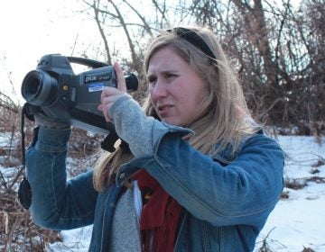 Researcher Melissa Sullivan uses an infrared FLIR camera to determine if methane is leaking from a well site. (Susan Phillips/StateImpact Pennsylvania)