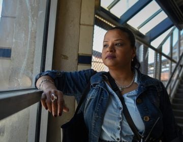 Roz Pichardo looks out the window at Kensington Avenue from inside the Somerset El station on April 27, 2019. Pichardo is a Kensington resident who works in the harm reduction community in the neighborhood. (Erin Blewett/Kensington Voice) 