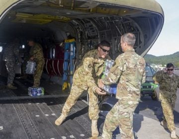 Pennsylvania National Guard Soldiers load bottled water onto a CH-47 Chinook helicopter September 1 at Fort Indiantown Gap in preparation to depart for the Hurricane Harvey relief effort in Texas. (U.S. National Guard photo by Sgt. Zane Craig)