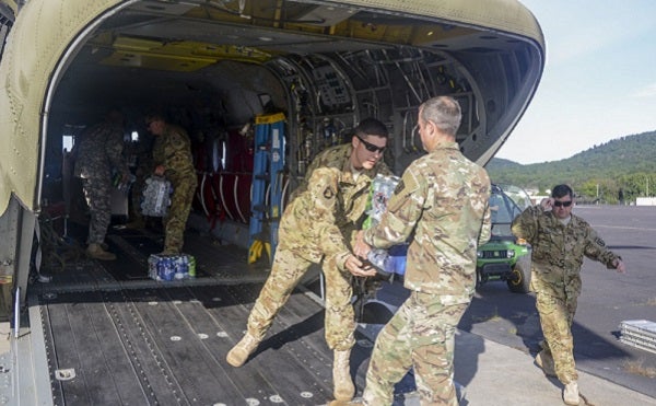 Pennsylvania National Guard Soldiers load bottled water onto a CH-47 Chinook helicopter September 1 at Fort Indiantown Gap in preparation to depart for the Hurricane Harvey relief effort in Texas. (U.S. National Guard photo by Sgt. Zane Craig)