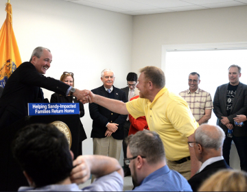New Jersey Gov. Phil Murphy shakes the hand of a man at a press conference Monday at the Shark River Municipal Marina in Neptune Township. (Image: N.J Office of the Governor)