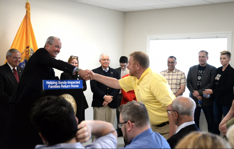 New Jersey Gov. Phil Murphy shakes the hand of a man at a press conference Monday at the Shark River Municipal Marina in Neptune Township. (Image: N.J Office of the Governor)