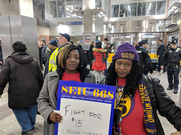 Home healthcare workers Stephanie Williams, left, and Lolita Owens rally at the Frankford Transportation Center in February to pressure state lawmakers to increase the state minimum wage to $15 an hour. (Michael D'Onofrio/Philadelphia Tribune)
