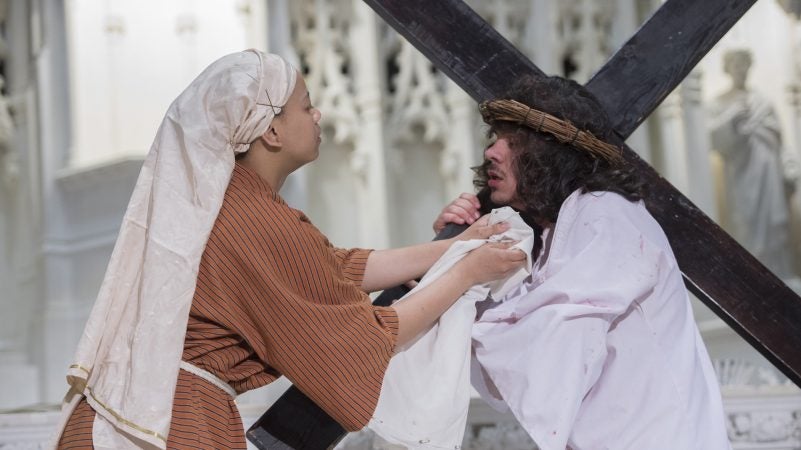 At the Sixth Station of the Cross, Veronica, portrayed by Tonya Mayo, wipes the face of Jesus. (Jonathan Wilson for WHYY)