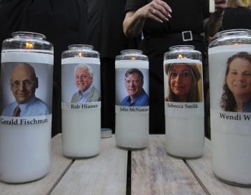 The photos of five people slain in the Capital Gazette newsroom adorn candles at a vigil in June. The attack was mentioned in the analysis of Reporters Without Borders' annual World Press Freedom Index. (Jose Luis Magana/AP)