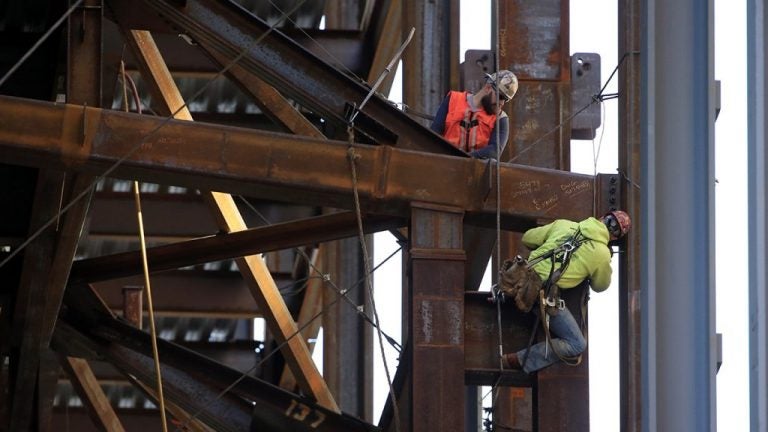 Iron workers help build the Comcast Innovation and Technology Center in Philadelphia. (Matt Rourke/AP Photo)