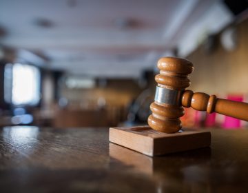 Color image of a gavel in a courtroom.