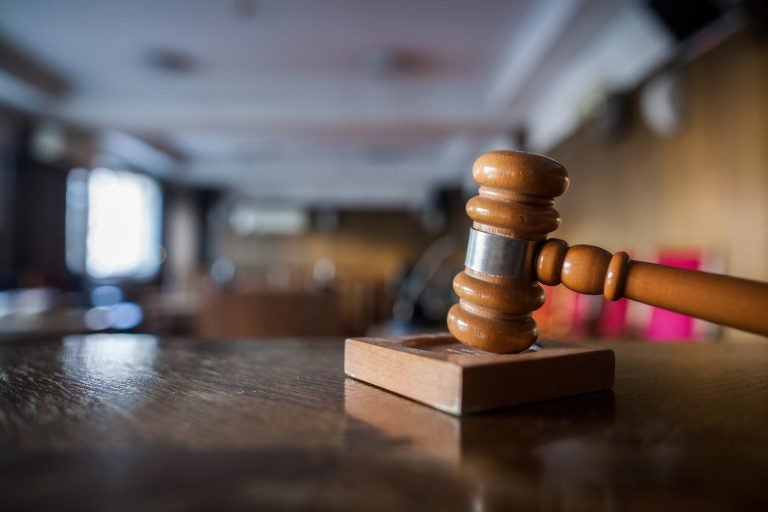 Color image of a gavel in a courtroom.