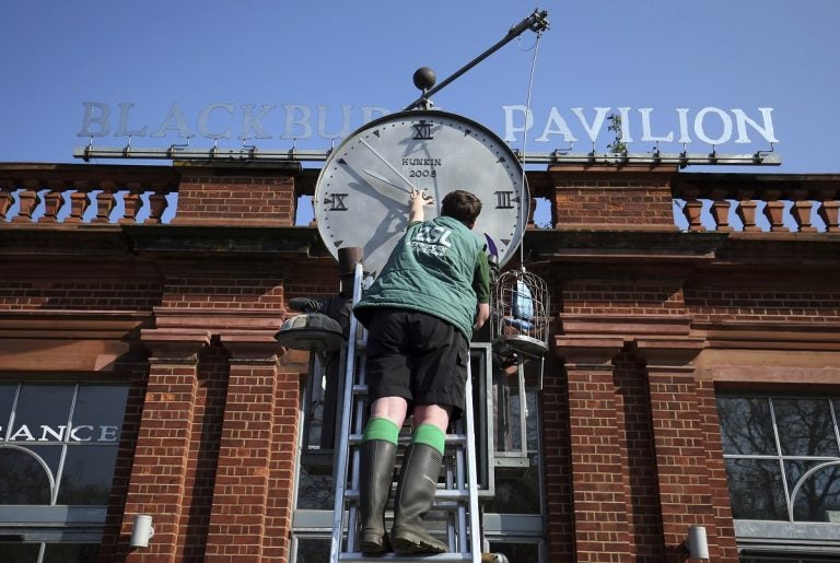 Daylight saving time Daylight saving time. ZSL London Zoo trainee keeper Jasmine Sinclair make adjustments to the Bird Clock, created by Tim Hunkin, which stands outside the Blackburn Pavillion at ZSL London Zoo in Regent's Park, London, ahead of this weekends daylight saving time. Picture date: Friday March 29, 2019. See PA story SOCIAL Clock. Photo credit should read: Jonathan Brady/PA Wire URN:42049163 (Press Association via AP Images)
