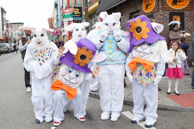 People dressed as Easter bunnies pose for a photo.