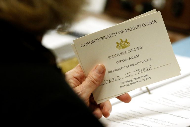 A Pennsylvania elector holds her ballot for President-elect Donald Trump before casting it in December 2016. (Jonathan Ernst/Reuters)