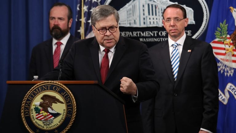 Attorney General William Barr speaks about the release of the redacted version of the Mueller report as U.S. Deputy Attorney General Rod Rosenstein (right) and U.S. Acting Principal Associate Deputy Attorney General Ed O'Callaghan listen at the Department of Justice Thursday in Washington, D.C. (Win McNamee/Getty Images)