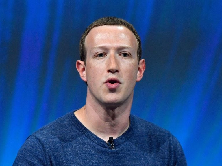 Facebook's CEO Mark Zuckerberg speaks at a trade fair in 2018. The company says it will use artificial intelligence to figure out which of its users have died.