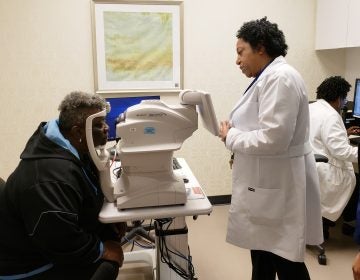 Nurse practitioner Debra Brown guides patient Merdis Wells through a diabetic retinopathy exam at University Medical Center in New Orleans. (Courtesy of IDx)