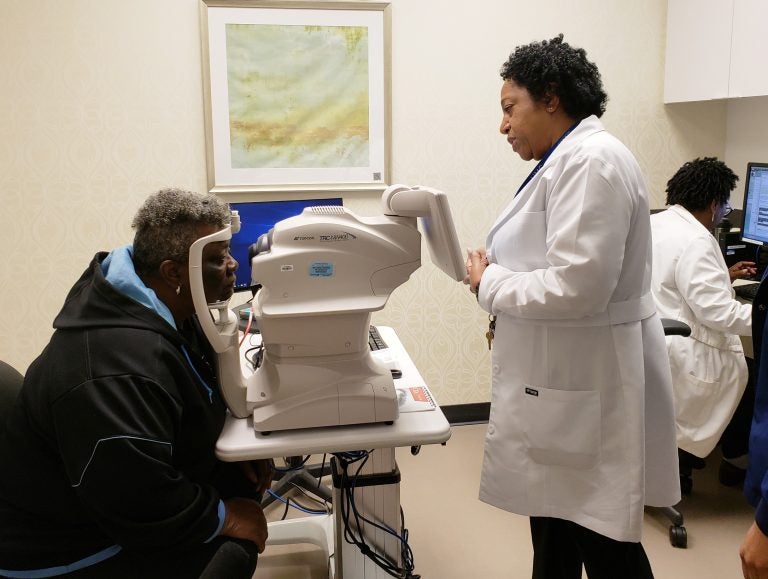 Nurse practitioner Debra Brown guides patient Merdis Wells through a diabetic retinopathy exam at University Medical Center in New Orleans. (Courtesy of IDx)