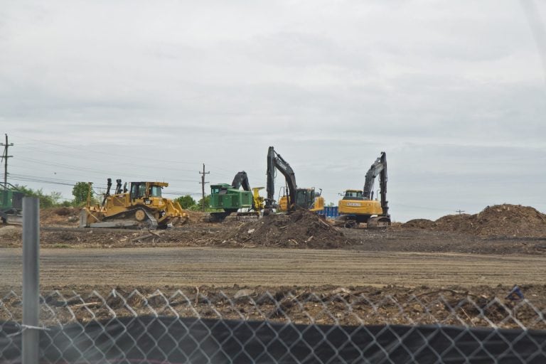 Crews work at the site of a sinkhole along the Mariner East pipeline route near the Pennsylvania State Police barracks on Route 1 in Delaware County on Thursday, April 25, 2019. Pipeline builder Energy Transfer/Sunoco said there were no leaks and no pipelines were exposed. (Kimberly Paynter/WHYY)