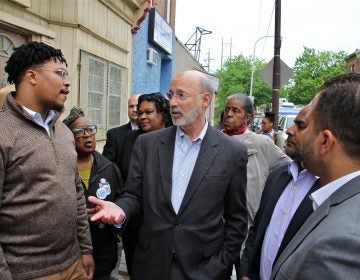 Pennsylvania Gov. Tom Wolf visits Fairhill, one of Philadelphia's poorest neighborhoods, to push for a severance tax on natural gas, which he says could be used to fight urban blight. (Emma Lee/WHYY)