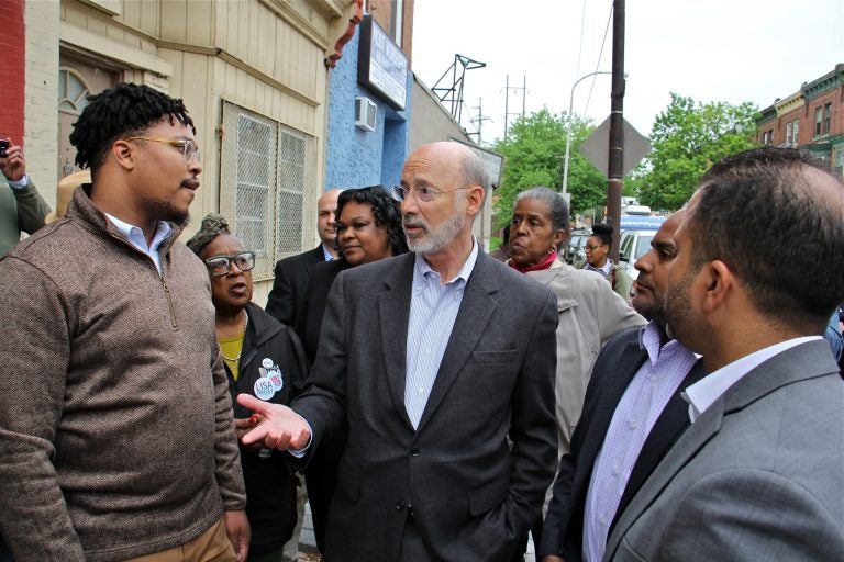 Pennsylvania Gov. Tom Wolf visits Fairhill, one of Philadelphia's poorest neighborhoods, to push for a severance tax on natural gas, which he says could be used to fight urban blight. (Emma Lee/WHYY)